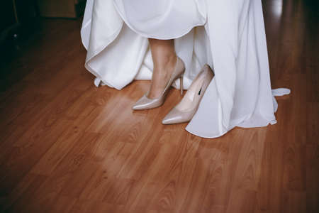 Bride Putting On Wedding Shoesの写真素材