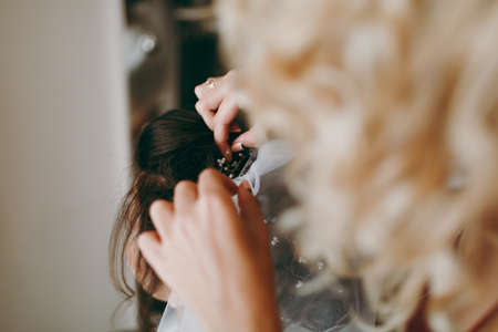 The bride is wearing a veil. Beautiful long veil of white colorの写真素材