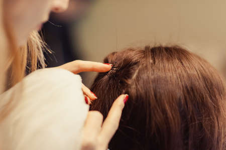 The bride is wearing a veil. Beautiful long veil of white colorの写真素材