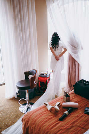 Amazing bride is watching in the windowの写真素材