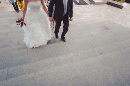 Feet of the groom and bride on the walkの写真素材