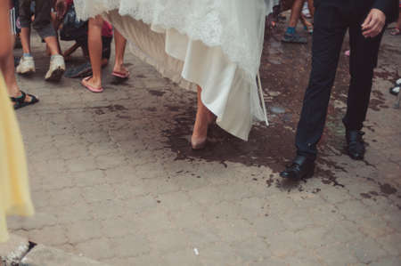 Feet of the groom and bride on the walkの写真素材