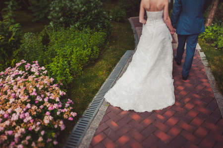 Feet of the groom and bride on the walkの写真素材