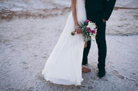 Groom and bride on the beachの写真素材