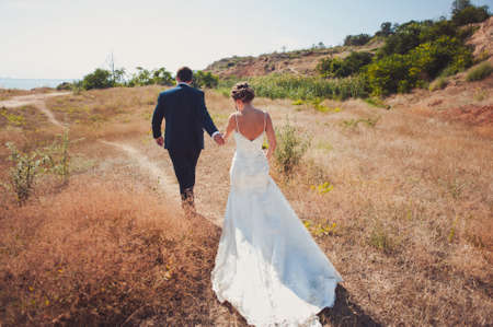 Wedding couple bride and groom on a walkの写真素材