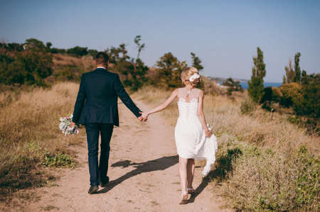 Wedding couple bride and groom on a walkの写真素材