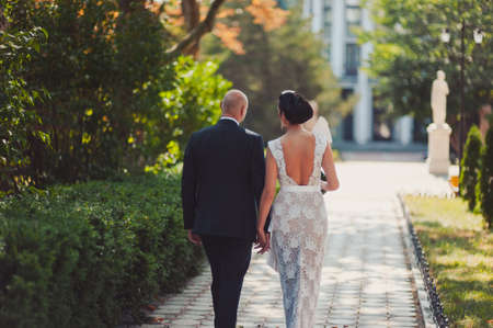 Wedding couple bride and groom on a walkの写真素材