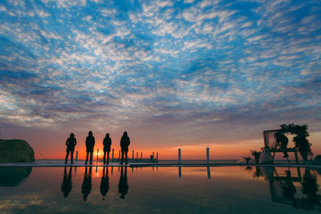 People on the beach near the sea meet the dawnの写真素材