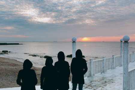 People on the beach near the sea meet the dawnの写真素材