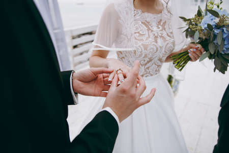 Putting on rings. The bride and groom dress ringsの写真素材