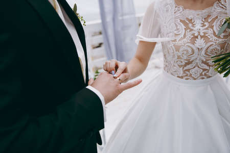 Putting on rings. The bride and groom dress ringsの写真素材