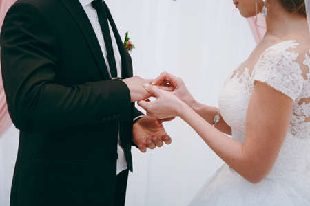 Putting on rings. The bride and groom dress ringsの写真素材