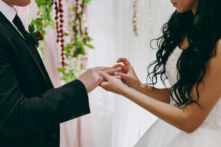Putting on rings. The bride and groom dress ringsの写真素材