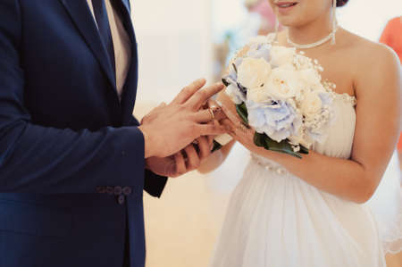 Putting on rings. The bride and groom dress ringsの写真素材