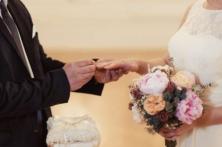 Putting on rings. The bride and groom dress ringsの写真素材