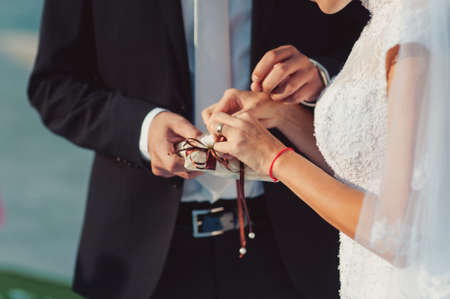 Putting on rings. The bride and groom dress ringsの写真素材