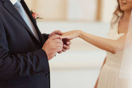 Putting on rings. The bride and groom dress ringsの写真素材