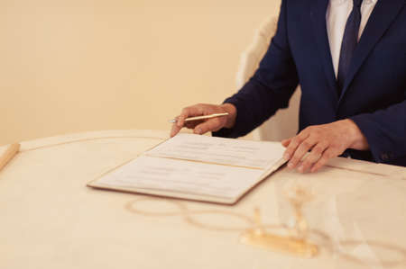 Signature Ceremony. The bride and groom sign the documents about the marriageの写真素材