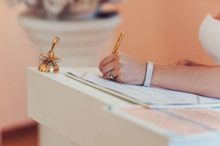 Signature Ceremony. The bride and groom sign the documents about the marriageの写真素材