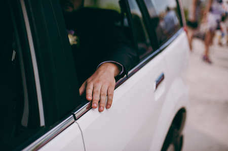 Man inside car showing his hand outdoorの写真素材