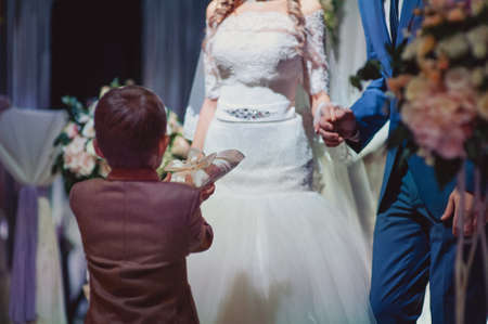 little girl or boy Carrying Wedding Ring On Cushionの写真素材