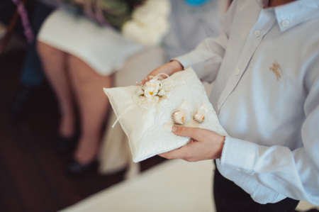 little girl or boy Carrying Wedding Ring On Cushionの写真素材