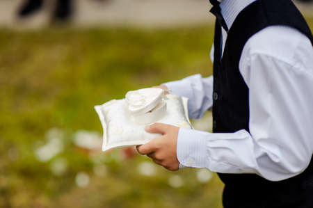 little girl or boy Carrying Wedding Ring On Cushionの写真素材