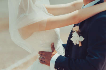 Close-up of a bride and groom in an embrace.の写真素材