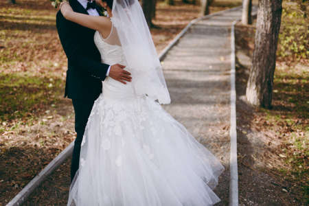 Close-up of a bride and groom in an embrace.の写真素材