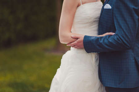 Close-up of a bride and groom in an embrace.の写真素材