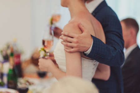Close-up of a bride and groom in an embrace.の写真素材