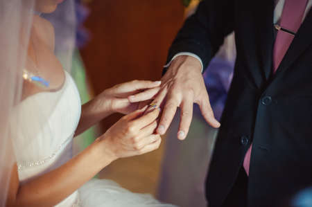 Putting on rings. The bride and groom dress ringsの写真素材