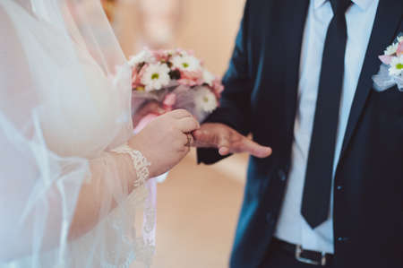Putting on rings. The bride and groom dress ringsの写真素材