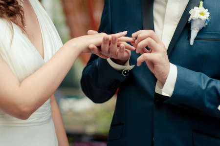 Putting on rings. The bride and groom dress ringsの写真素材