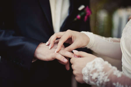 Putting on rings. The bride and groom dress ringsの写真素材