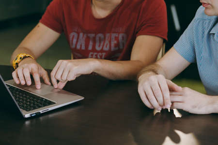 Working at home with laptop. Close-up of typing men hands on keyboard.の写真素材