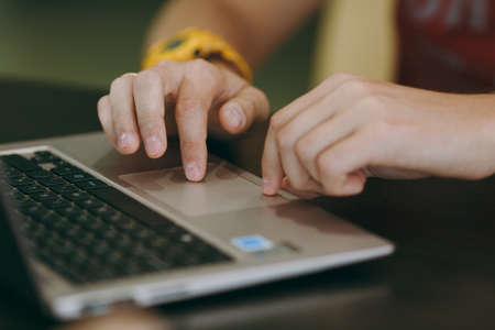 Working at home with laptop. Close-up of typing men hands on keyboard.の写真素材