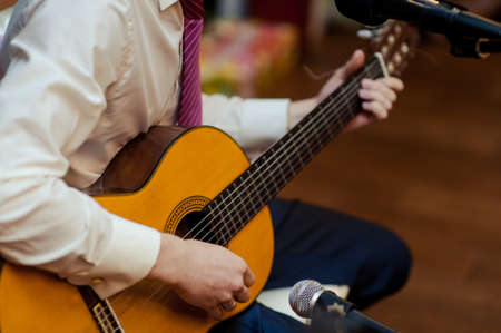 Handsome young men playing guitarの写真素材