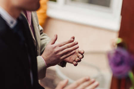 people applauding, clapping hands at wedding reception or meetingの写真素材