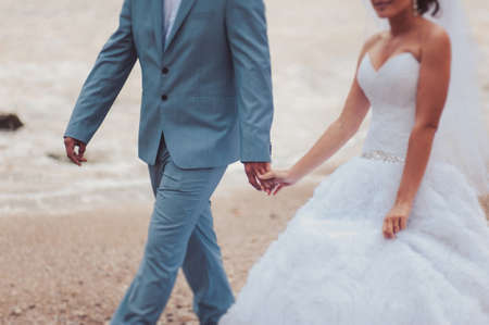 Holding hands. Closeup view of married couple holding handsの写真素材