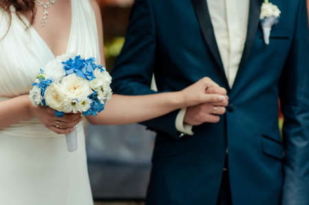 Holding hands. Closeup view of married couple holding handsの写真素材