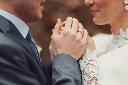 Holding hands. Closeup view of married couple holding handsの写真素材