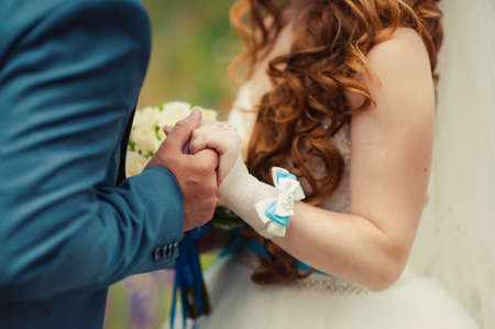 Holding hands. Closeup view of married couple holding handsの写真素材
