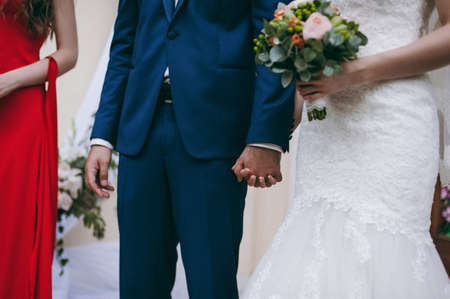 Holding hands. Closeup view of married couple holding handsの写真素材