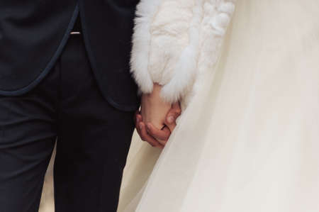 Holding hands. Closeup view of married couple holding handsの写真素材