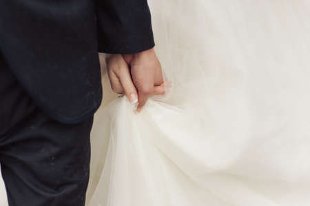 Holding hands. Closeup view of married couple holding handsの写真素材