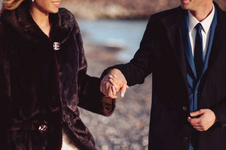Holding hands. Closeup view of married couple holding handsの写真素材