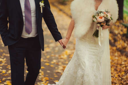 Holding hands. Closeup view of married couple holding handsの写真素材