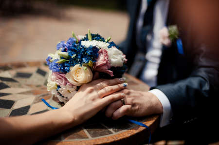 Holding hands. Closeup view of married couple holding handsの写真素材