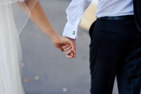 Holding hands. Closeup view of married couple holding handsの写真素材